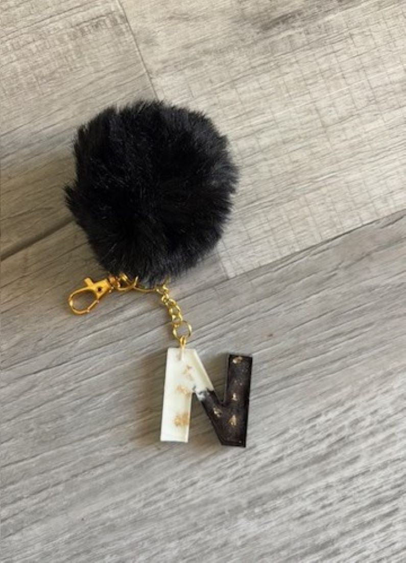 Fun and Functional!
Lightweight initial N keychain with Pom-Pom, White and Black With Gold Flakes.
Split Ring will hold several keys or large lobster claw will attach to purse or backpack
Initial is approximately 1.5 inches tall