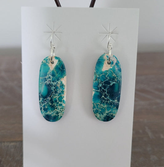 Such interesting matrix in these slab earrings. They look like an aerial view of the ocean. The label on the card says Blue Indigo, but they are turquoise. Sterling Silver French Hooks. (I replaced the hooks already on the earrings because I was not sure if they were Sterling) Approximate length: 1.75 inches long as they would hang. MSRP: $75