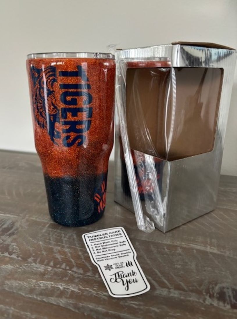 Show your school spirit! Orange and blue glitter gleam under three coats of epoxy. Tiger face on one side and “it’s a great day to be a tiger” on the other. Orange tiger paws with blue stripes on two sides.
30 oz.
Double walled Stainless Steel cup will keep your drinks hot or cold for hours.
Comes with gift box, lid and plastic straw as shown.
Hand wash only. Not dishwasher safe.