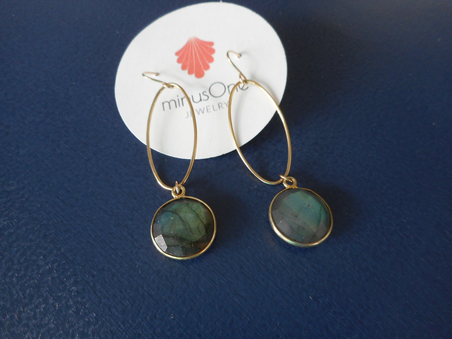 Smoky blue green round stones dangle from thin gold filled (vermeil) ovals. Overall length is approximately 2.5 inches. French hooks.