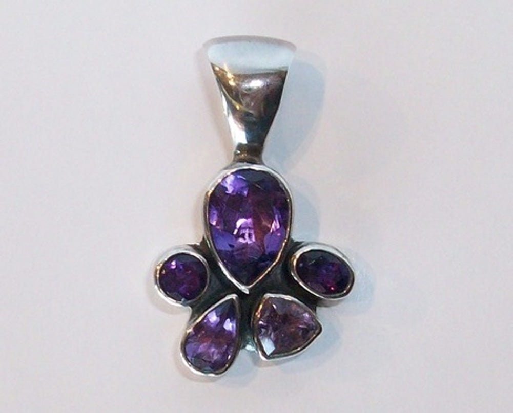 5 faceted stone Amethyst pendant set in Sterling Silver. Large bail for large chain. Looks like a paw print.