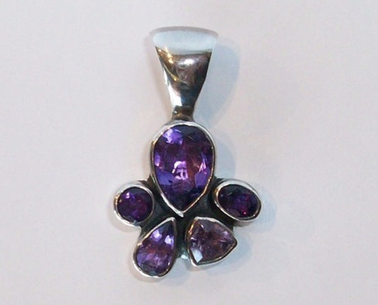5 faceted stone Amethyst pendant set in Sterling Silver. Large bail for large chain. Looks like a paw print.