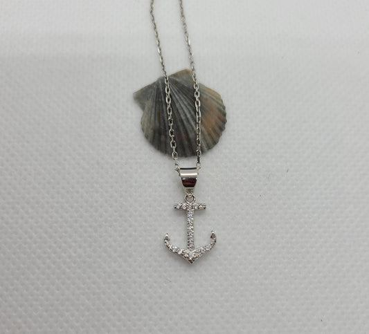 Beautiful anchor necklace is Sterling Silver with CZs. Both anchor and chain are Sterling Silver with Rhodium plating. Never needs polishing. Chain is approximately 18 inches long Nisha Design MSRP: $45