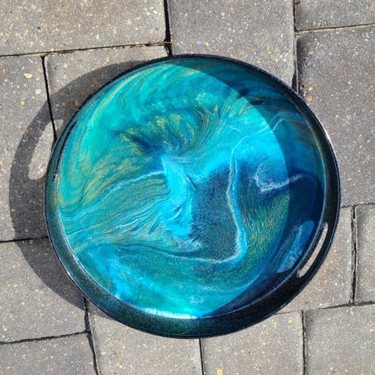 This is an elegant piece with a lot of sparkle. Use for serving bubbly champagne or just sitting on the table. The tray is a heavy-weight plastic. Cut out handles on the sides. Black with silver sparkles. The inside of the tray picks up the gold tones and makes it look like there is gold glitter too! Dramatic design in blues, gold, green and white. Truly one of a kind. I won't ever be able to recreate this piece! Approximate size: 13 inches round, 2 inches deep