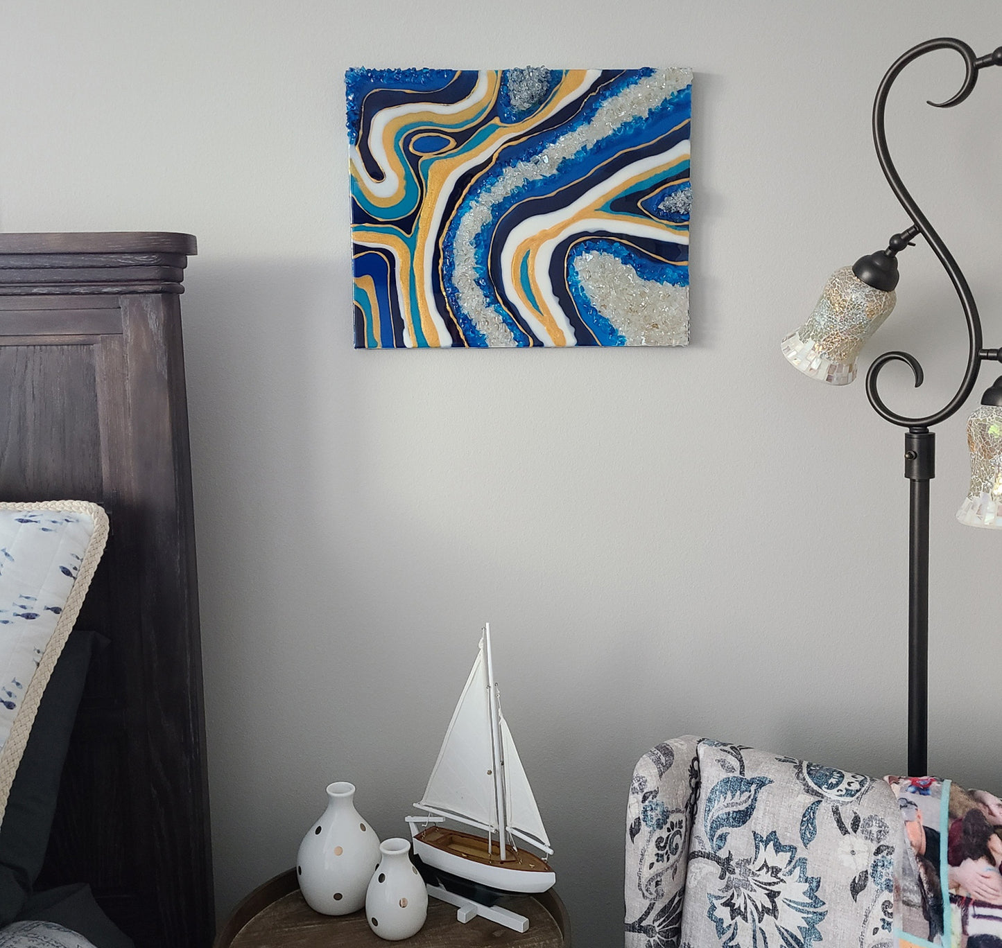 Wall Art on MDF Board. Resin in Blues, Gold and White surround chunks of blue and white glass. Looks like a large geode. 16 x 20 inches. Handcrafted, one of a kind art.