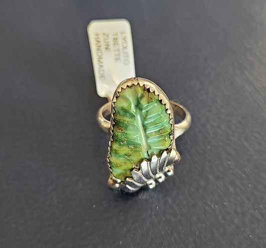 Beautiful shades of green and blue with gold veins. Called Sonoran Gold turquoise. Set in a Sterling Silver saw-toothed bezel with a Sterling Silver leaf on one end. Size 10. Zuni Artist Lyolita Tsatte. Etched inside the ring is Lyolita Tsatte Zuni.