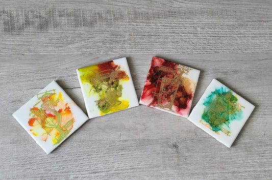 I did this set using alcohol inks and embossed them with 4 different designs of cocktails: Margarita, Bloody Mary, Martini and Tropical. Very festive addition to your Happy Hour. Tiles are covered in UV and Heat Resistant resin. Cork backs protect furniture. Each tile is 4 x 4 inches. Care: Wipe with a damp warm cloth. DO NOT microwave or place in dishwasher.