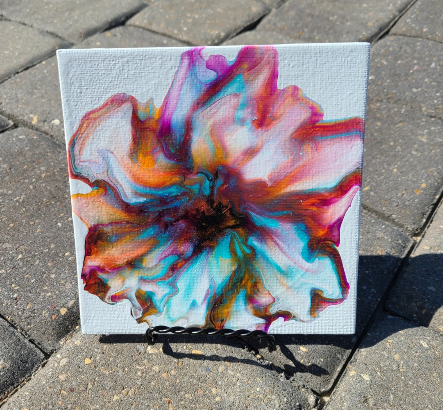 I recently did this little bloom that I named "Coppery Bloom", but it has so many more colors in it. Petals of turquoise, purple, orange, black and copper on a white background. Created on a thin Artist Panel. Comes with the small twisted wire easel as shown to sit about your home or can be easily put into a frame. 6 x 6 inches