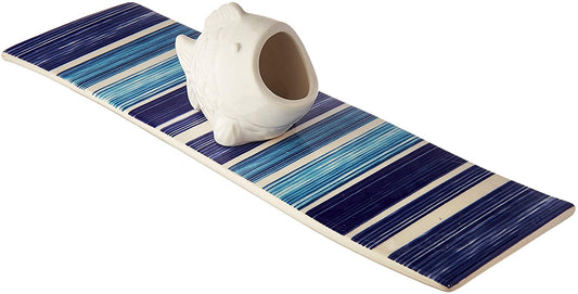 Ceramic rectangle shaped tray has a slight wave to it. Design is called watercolor. Various shades of blue with white stripes. White ceramic fish has a large mouth for holding toothpicks. Tray measures 12 x 3.5 inches.