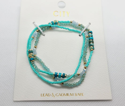 set of 3 fashion bracelets. one is all small turquoise beads, one is a mix of turquoise heishi, gold tone beads and crystals. The other is faceted crystal beads and gold tone beads.