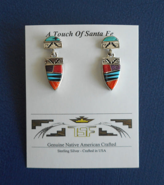 Native American made in the USA. These earrings look like a kachina or Yei to me. The stud part has a half moon piece of turquoise on Sterling Silver. The bottom part dangles from a silver ring and has inlaid Sugilite, Spiny Oyster, Onyx and Turquoise.