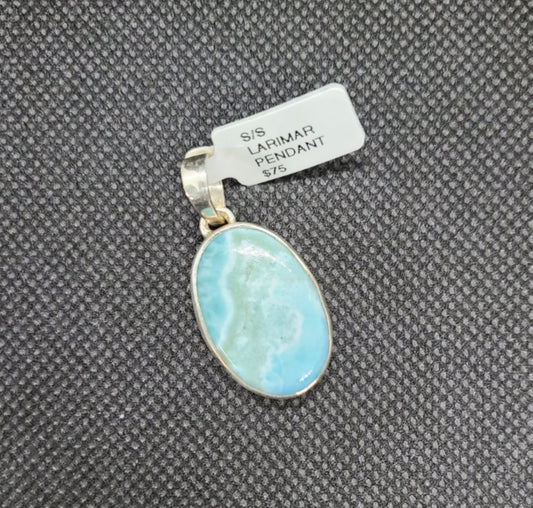 Clean and sleek. Striking Larimar stone is set in a contemporary Sterling Silver design. Sanchai and Filia Designs Also known as the Blue Jewel of the Caribbean. Larimar or blue pectolite is an extremely rare gemstone. It has been found only in one location: a mountainous, relatively inaccessible area in the province of Barahona in the Dominican Republic. Open back to keep the piece lightweight Approximate size: 1.25 inches long including bail