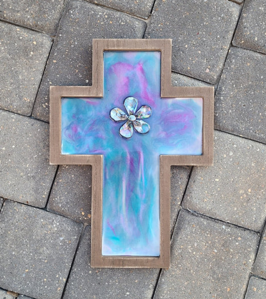 Sparkling colors of Purple, magenta, teal and pearl in this beautiful cross. Resin In the Center, I placed abalone shells and a peacock pearl Wood MDF cross with saw tooth hanger on the back Approximate size: 14.25 x 10 inches