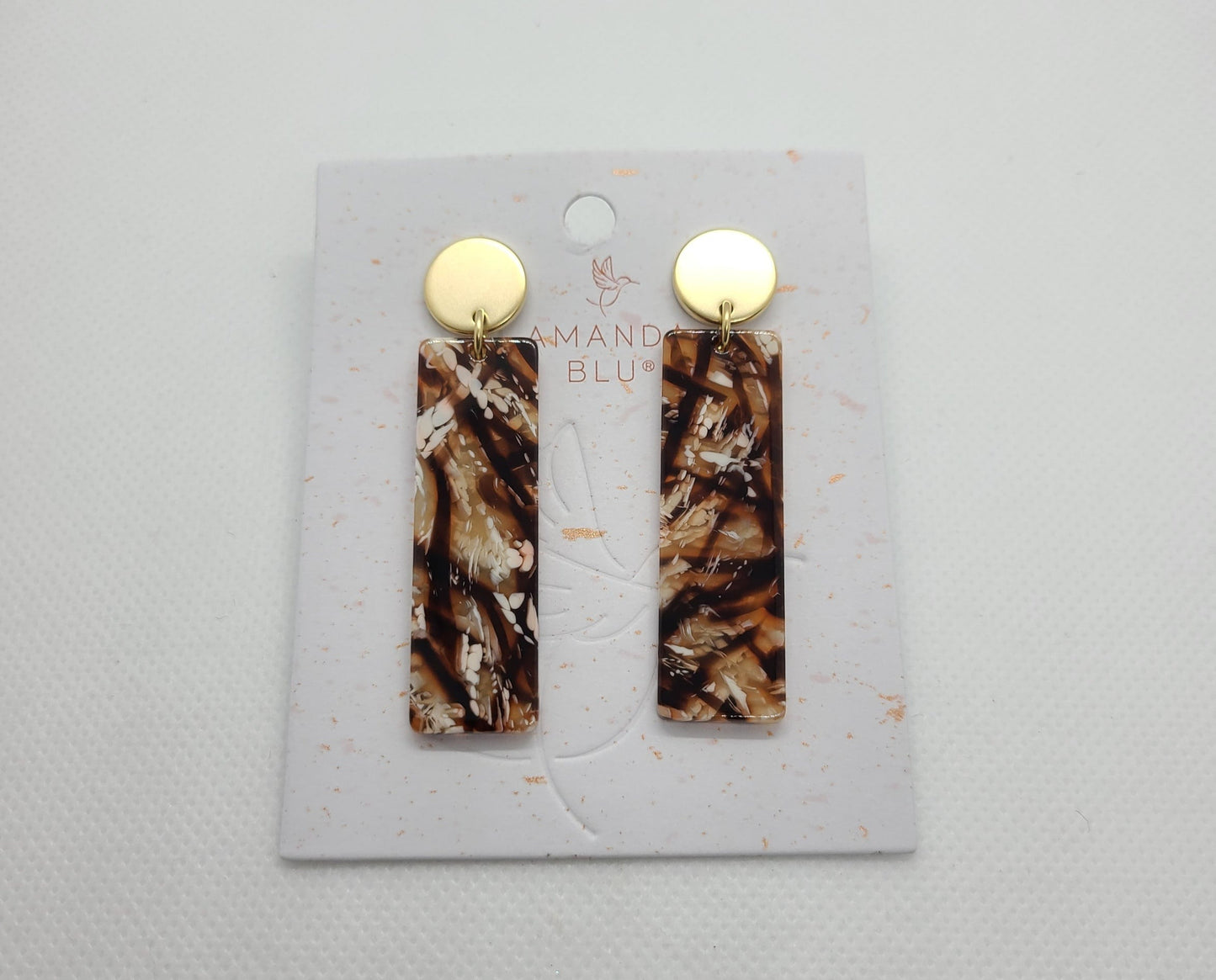 New! Chic rectangular drop earrings. The browns, black and white will elevate any fashion, from casual wear to your most elegant black dress. Very lightweight, made of acetate and 18K Gold Plating. Posts are Surgical Steel. Handmade, no two are exactly alike. The first photo is a stock picture, the others are of the actual earring. Studs come with both disk backing and rubber stopper as shown. Approximate length: 2.25 inches from center of stud.