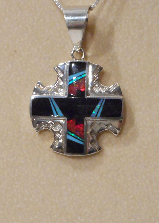 Stunning Sterling Silver Cross Pendant with equal sides. Inlaid over the silver is onyx, turquoise, opal and red fire opal. Total length including the bail is 1.75 inches. Large bail to fit almost any necklace.
