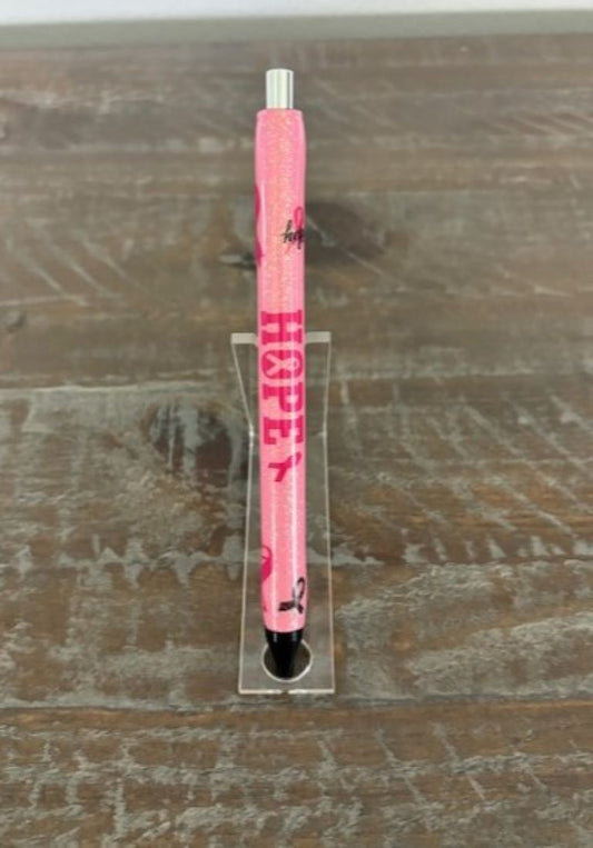 I made this pen in honor of all my friends and family that have fought breast cancer.&nbsp; I used pink and iridescent glitter and decorated it with hope and the iconic pink ribbon.&nbsp; I used two coats of resin to cover the stickers and glitter so that it feels nice and smooth.  The pen is a gel pen and can be easily refilled by unscrewing the end.&nbsp; There is a red wax tip covering the end so that the gel doesn't leak out.&nbsp; That is easily removed with your fingernail.