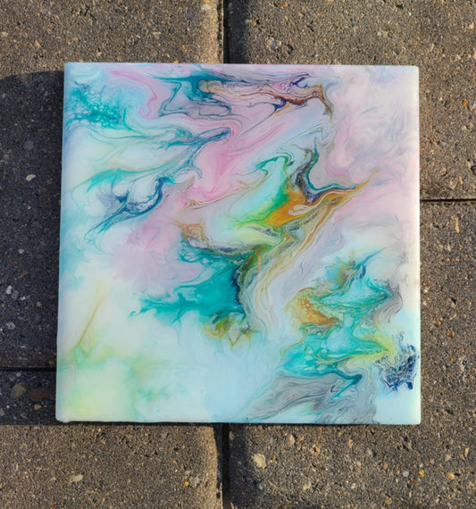 This pastel artwork reminds me of soft summer skies and ocean waters.  Soft pastels of blue, green, pink, and gray.  Artwork is acrylic with two coats of resin.  Can be used as a trivet or displayed on the wire easel shown. (Included if you want.  Leave a message if you do want it)  UV Resistant and Heat Resistant Resin.  Food Safe too.  Cork backing to protect countertops or furniture.  Approximate measurements: 6 x 6 inches