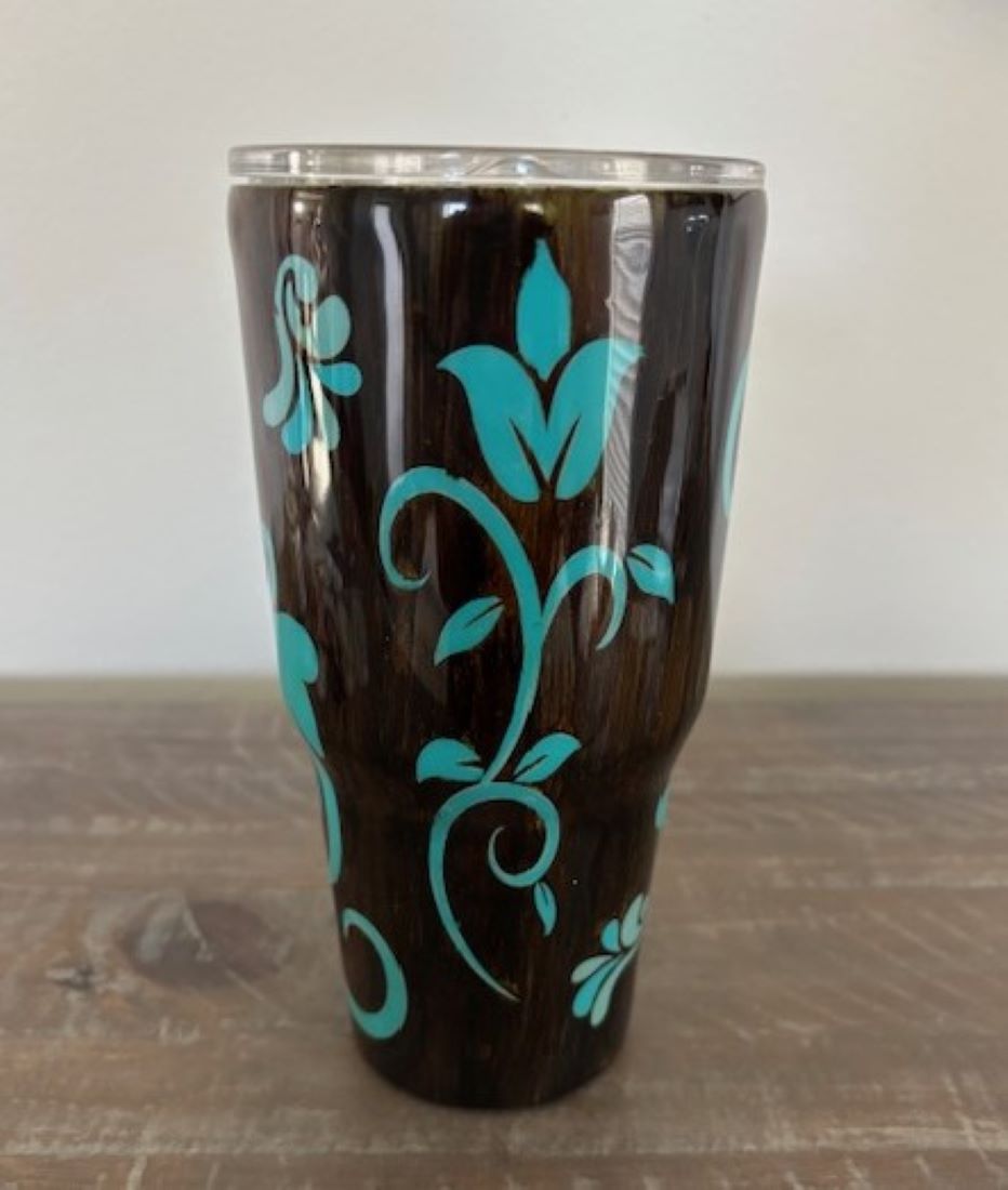 This hand painted Tumbler has a wood grain. Look with a look of tooled leather design.
Dark brown with turquoise design. Coated with UV resistant and food safe resin.
30 oz
Double stop stainless steel walled Tumbler will keep your drinks cold or hot for hours.
Plastic splash proof lid, and straw included
Care: hand wash only, not dishwasher safe, not microwave safe.