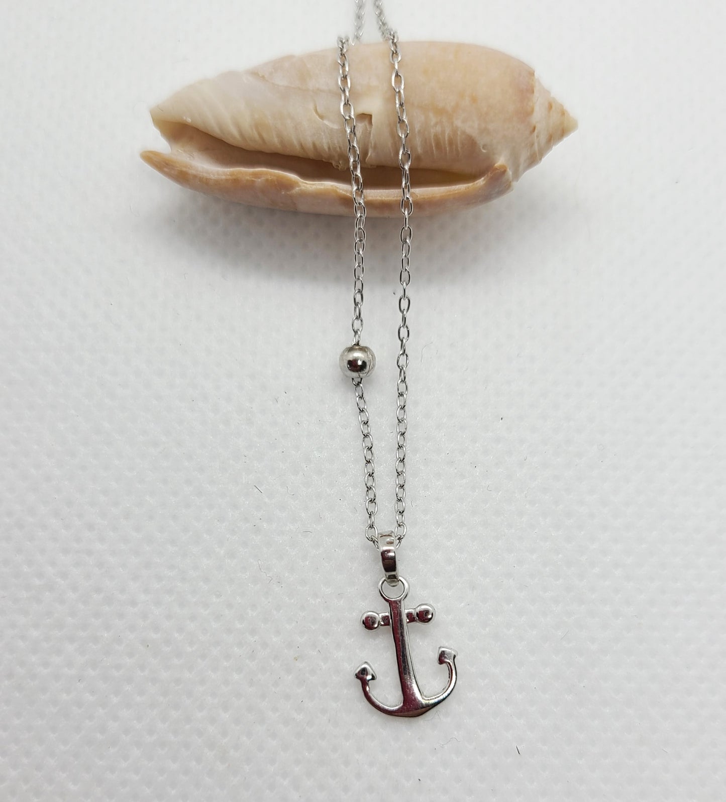 Petite Necklace  Small anchor with floating bead.  Sterling Silver with Rhodium Plating, Never Needs Polishing  Chain is approximately 16 inches long, Plus extension on necklace adds another 1.5 inches