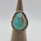 Beautiful Kingman Turquoise Ring has pear shaped stone.  Light greens gently fade into light blue with brown matrix.  Bezel set in Sterling Silver with twisted rope.  Backplate has saw cuts.   Split Band Navajo Artist, Dave Skeets Size 8 Stamped: Sterling, Skeets (the band is over part of his name) Certificate of Authenticity guarantees Native American Made 