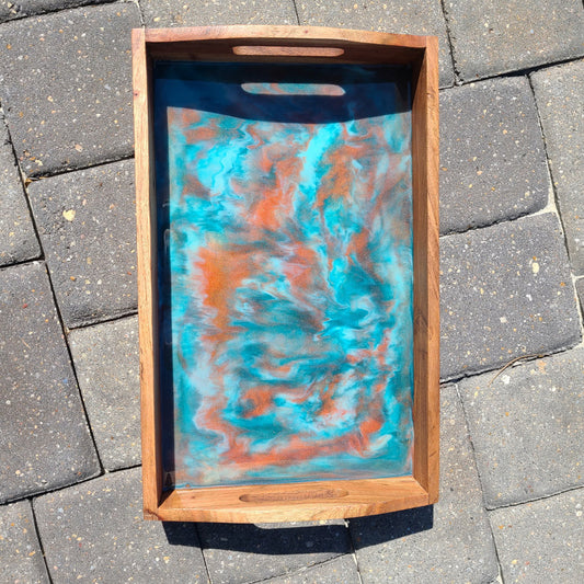 The copper color really pops among the teals and white swirls.  Wood tray has handles cut out of the ends.  Resin is UV Resistant and Food Safe.  Protective Feet on the bottom to protect your furniture and countertops.  Care: Wipe resin with a damp cloth or an alcohol wipe.  Occasionally treat the wood with Food Grade Mineral Oil or Olive Oil.  Approximate size: 16 x 10 inches