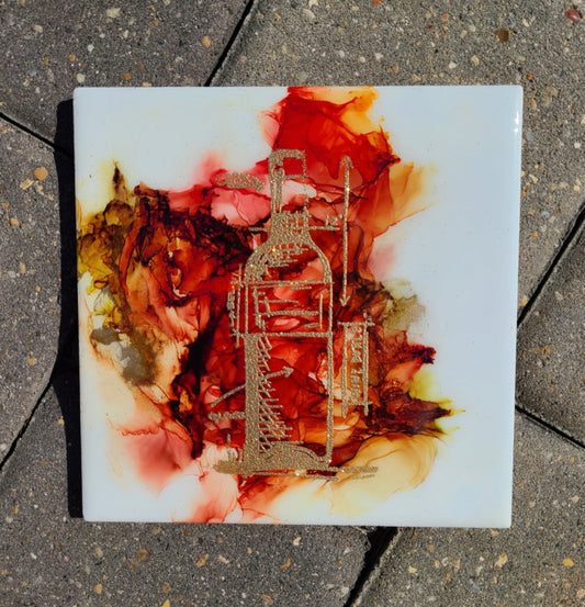 Sparkling Gold Wine Bottle on an Alcohol Ink background. Looks like stained glass. Wine Bottle image is a blue print design. Ceramic Tile With Cork Back. Can be used as a trivet or it can be put on an easel to be used as a piece of art. Approximate size: 6 x 6 Inch Heat Resistant Resin over the gold embossed wine bottle.