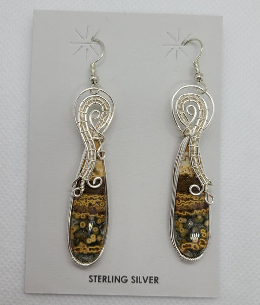 So Unusual! These dangle earrings remind me of an octopus wrapping around the brown, beige and black stone. Sterling Silver design holds the beautiful speckled stone. Approximate size: 2.6 inches as they hang MSRP: $175