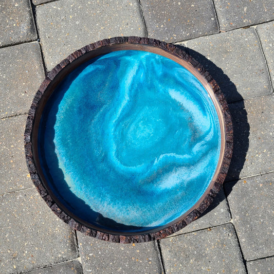 This tray is a little more subtle than I usually do. The rings of water look like you're looking into a deep hole.  Round Wood tray with bark edge  Resin is food safe and UV Resistant  Approximate size: 14 x 2 inches  Care: Wipe with a clean damp cloth. Wood can be conditioned with Food Grade Mineral Oil or Olive Oil.