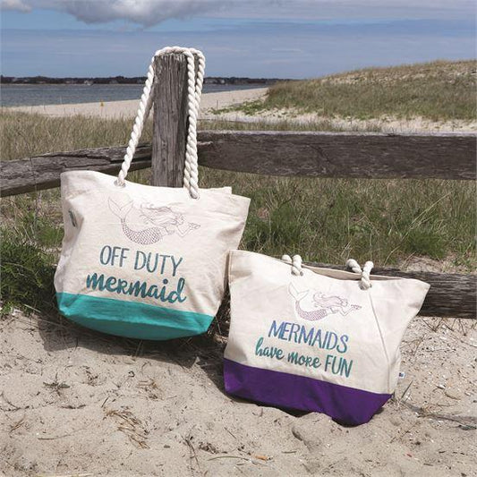 Canvas Tote with purple bottom has a soft rope handle. One side has a mermaid and reads, "Mermaids have more fun". The other side is solid. 22 x 15