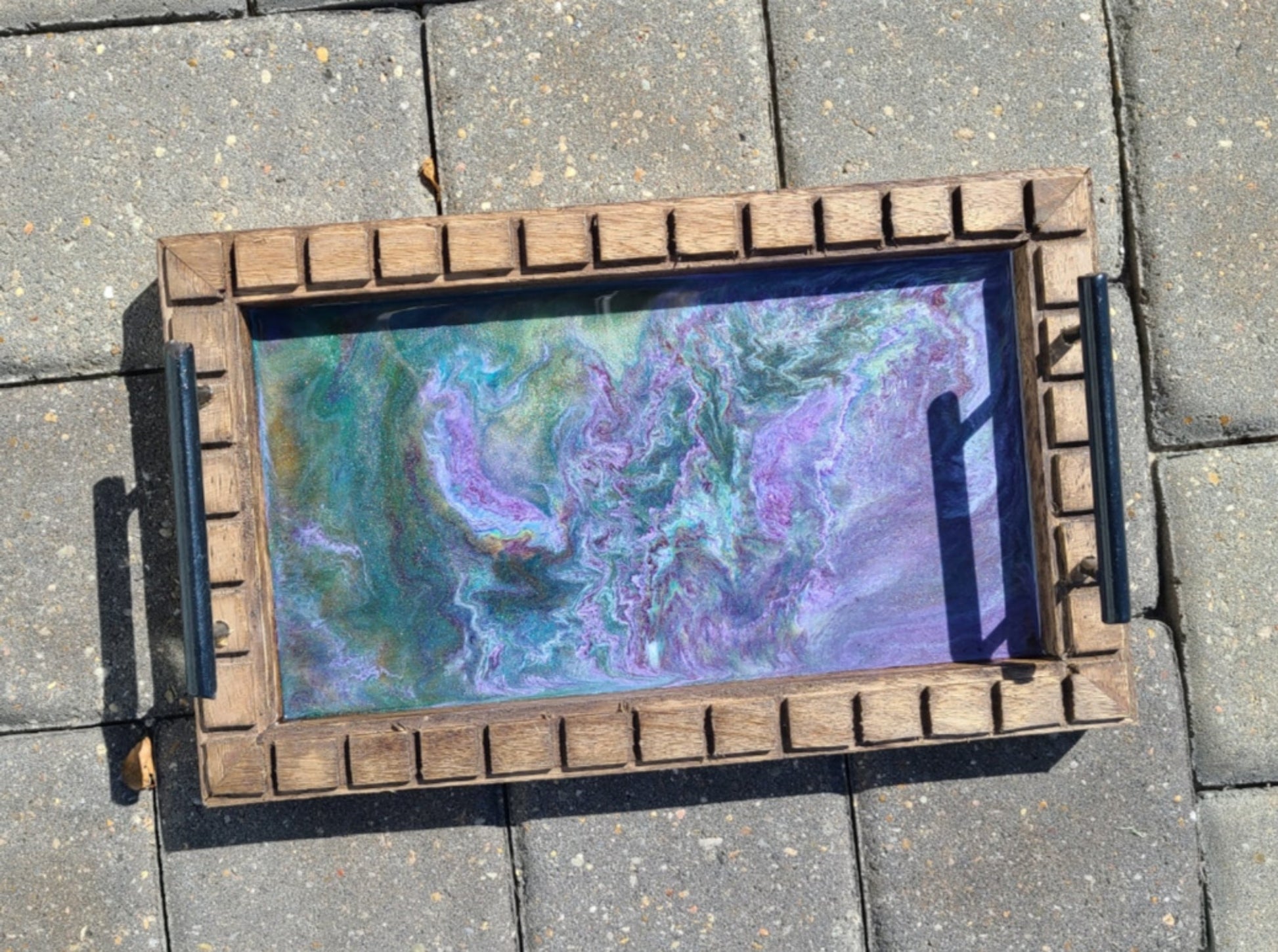 I love the way these colors play together!  The purple and green together with a little white resin came together to form what looks like an amethyst rock in it's natural formation. Metal handles Rectangular wood tray with saw cuts around the top edge. Resin is UV resistant and food safe Felt feet on the bottom to protect furniture  Approximate size: 14 x 8.5 x 1.25 inches Wipe resin with a damp cloth or alcohol wipe to clean.