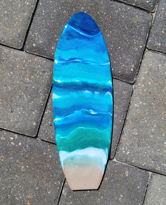 Oh, how these colors sparkle!  All the blues, greens and "sand" sparkle.  The white waves add movement to the water.  Done on a MDF board. Lightweight.  Resin is UV Resistant.  Saw tooth hanger on the back.  Approximate size: 12 x 4 inches.