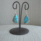 Kingman Turquoise dangle earrings. Beautiful shades of blue in the stunning earrings.  Set in Sterling Silver with beads of silver accent on the top and bottom of these freeform stone earrings.  Artist Sharon McCarthy. Approximately 1.5 inches long.  Native American. Comes with Certificate of Authenticity.